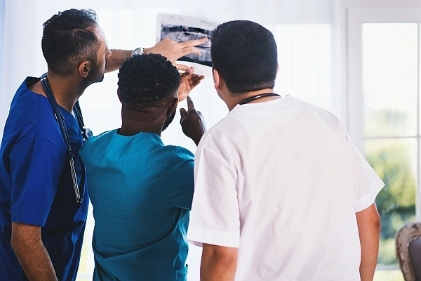 Medical staff looking at x-ray