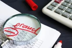 Workers Compensation Fraud, Financial Document With Magnifying Glass
