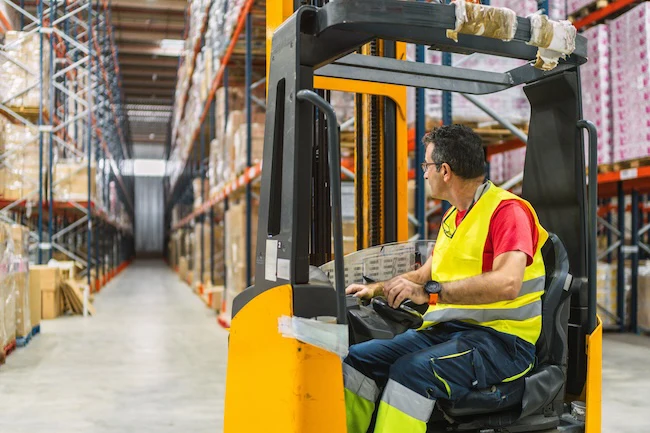 Miami-Dade warehouse workers in distribution center with forklifts and inventory racks