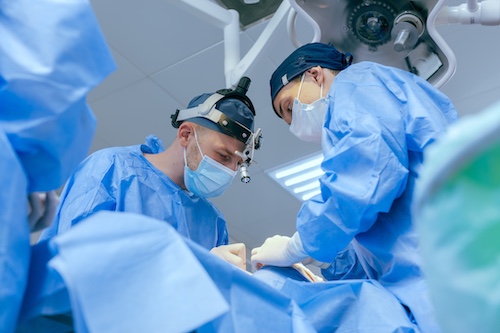 Surgeons Conducting Surgery on Patient - Surgery Approval