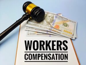 Workers' Comp Settlement Concept With Money and Gavel
