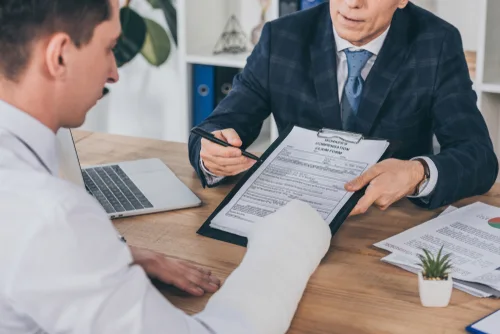 Kissimmee workers' comp lawyer discussing benefits with client