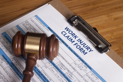 Work injury claim form and gavel
