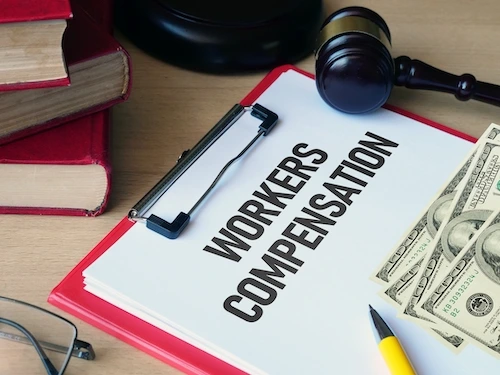 Workers' Compensation paperwork, money, and gavel